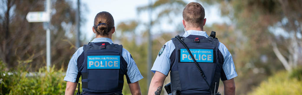 The back of two police officers walking together 