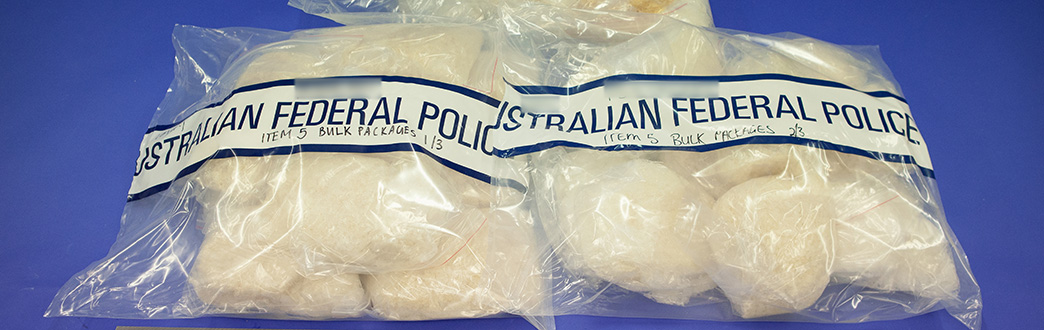 A picture of illicit drugs in a bag with Australian Federal Police tape 